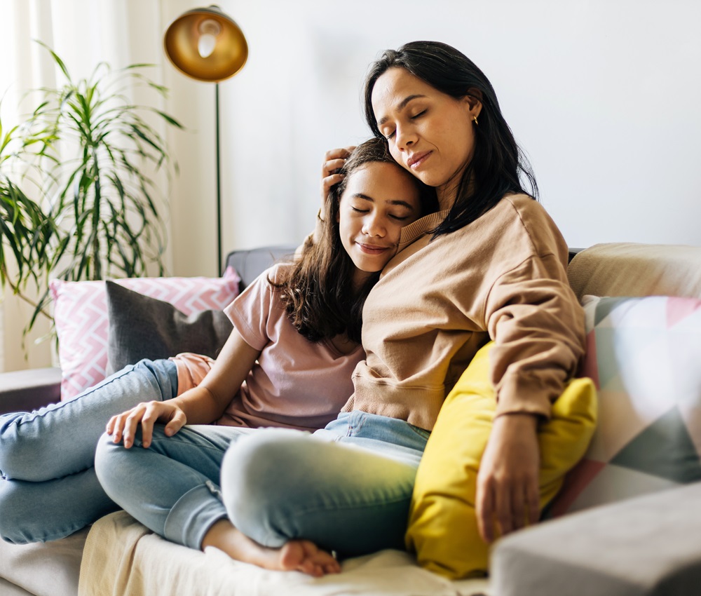 mom and daughter sitting on couch