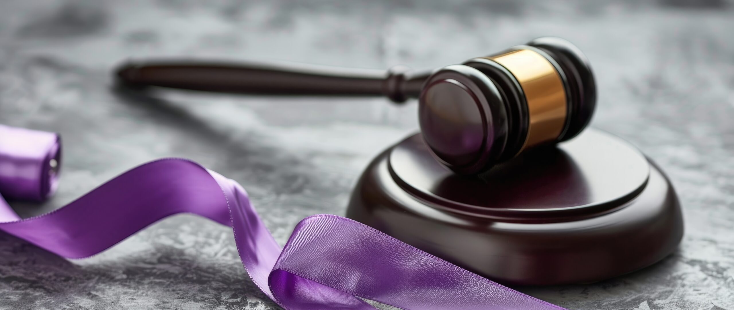 Concept of Domestic Violence Law Represented by Violet Ribbon and Gavel on Grey Background
