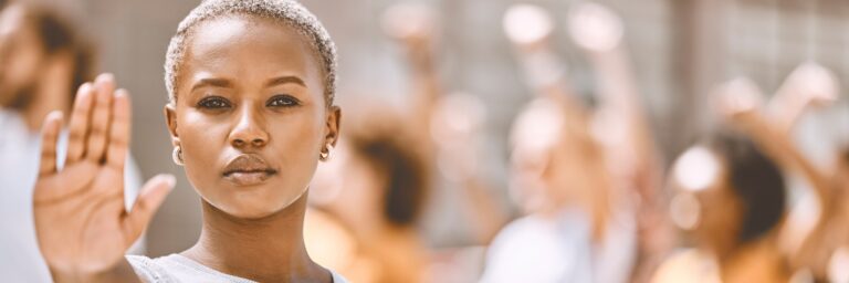 Black female holding up hand to stop