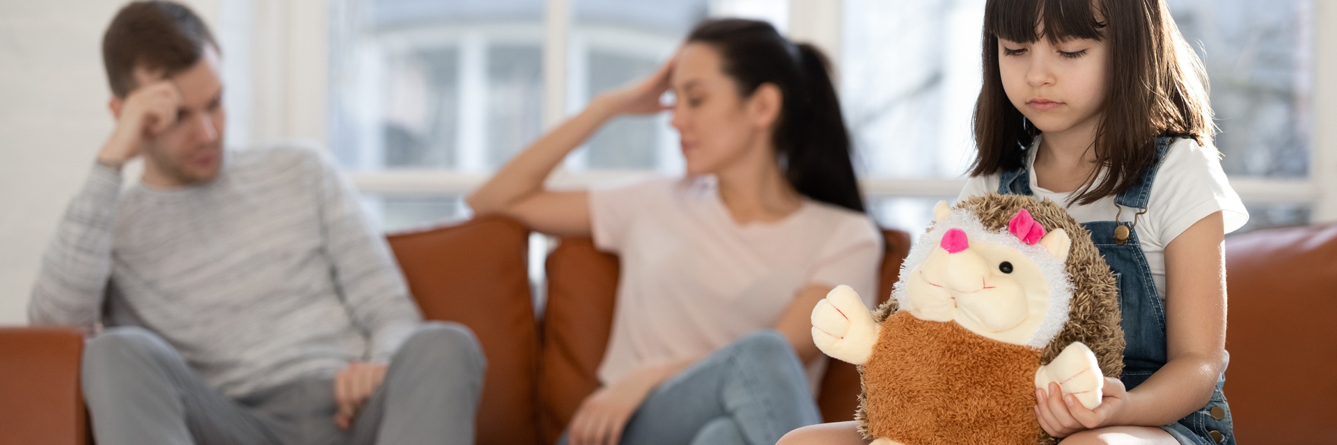 young girl loks away while parents argue
